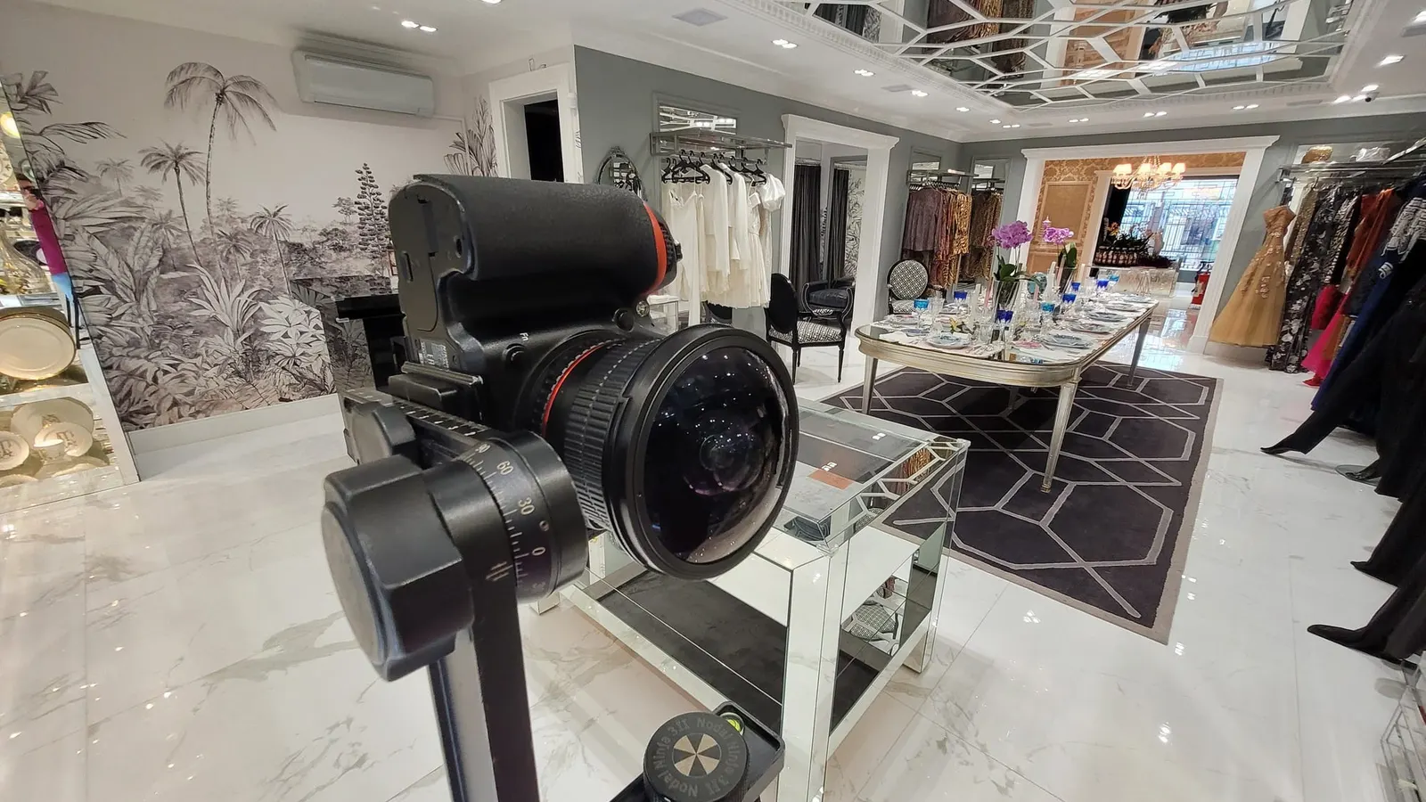 Câmera Nikon com lente olho de peixe na cabeça panorâmica Nodal Ninja 3, no salão do Atelier Sandro Barros, com teto de espelhos em treliça, piso de mármore polido, mesa posta e araras de vestidos ao fundo